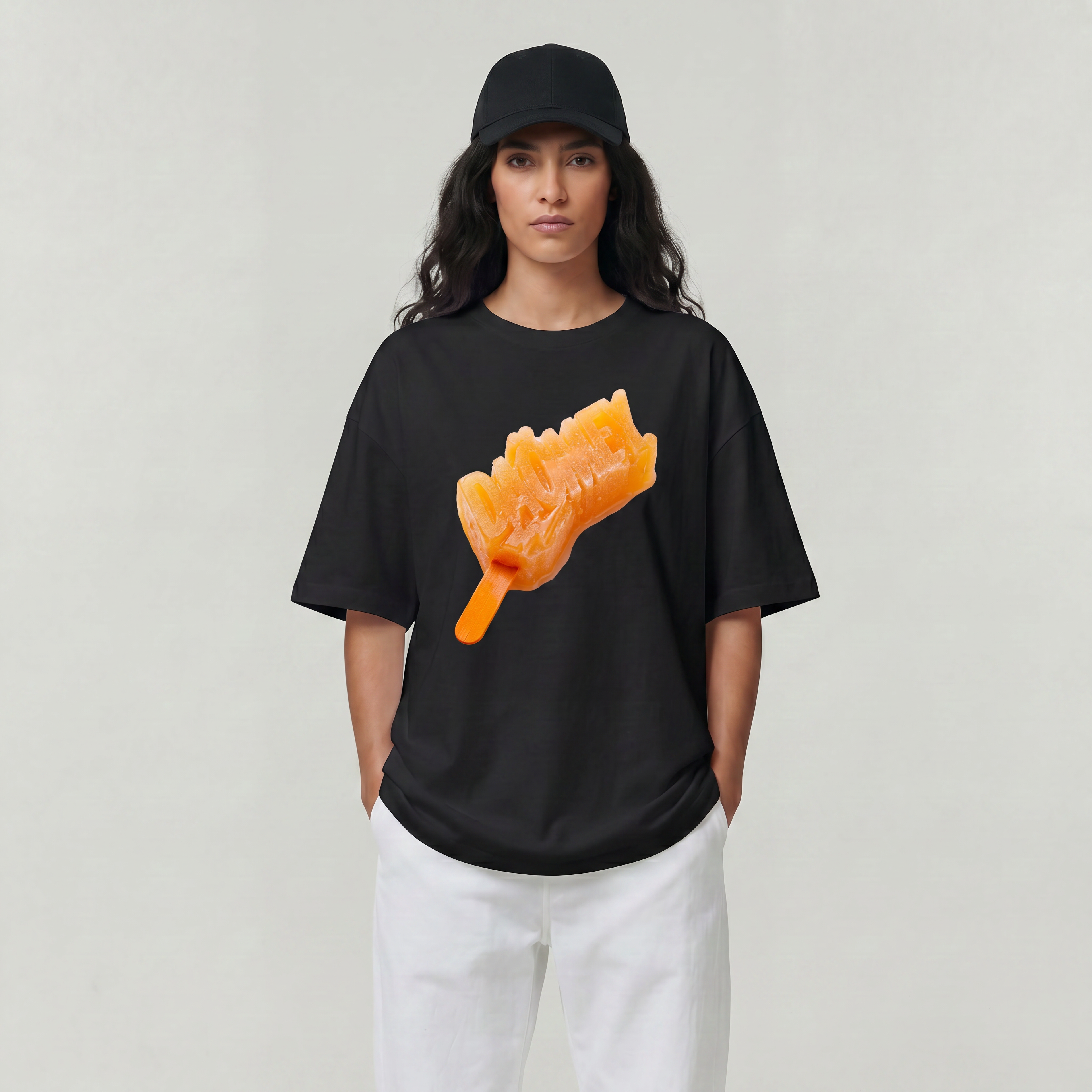 Person wearing a black t-shirt with an orange graphic design on a plain background