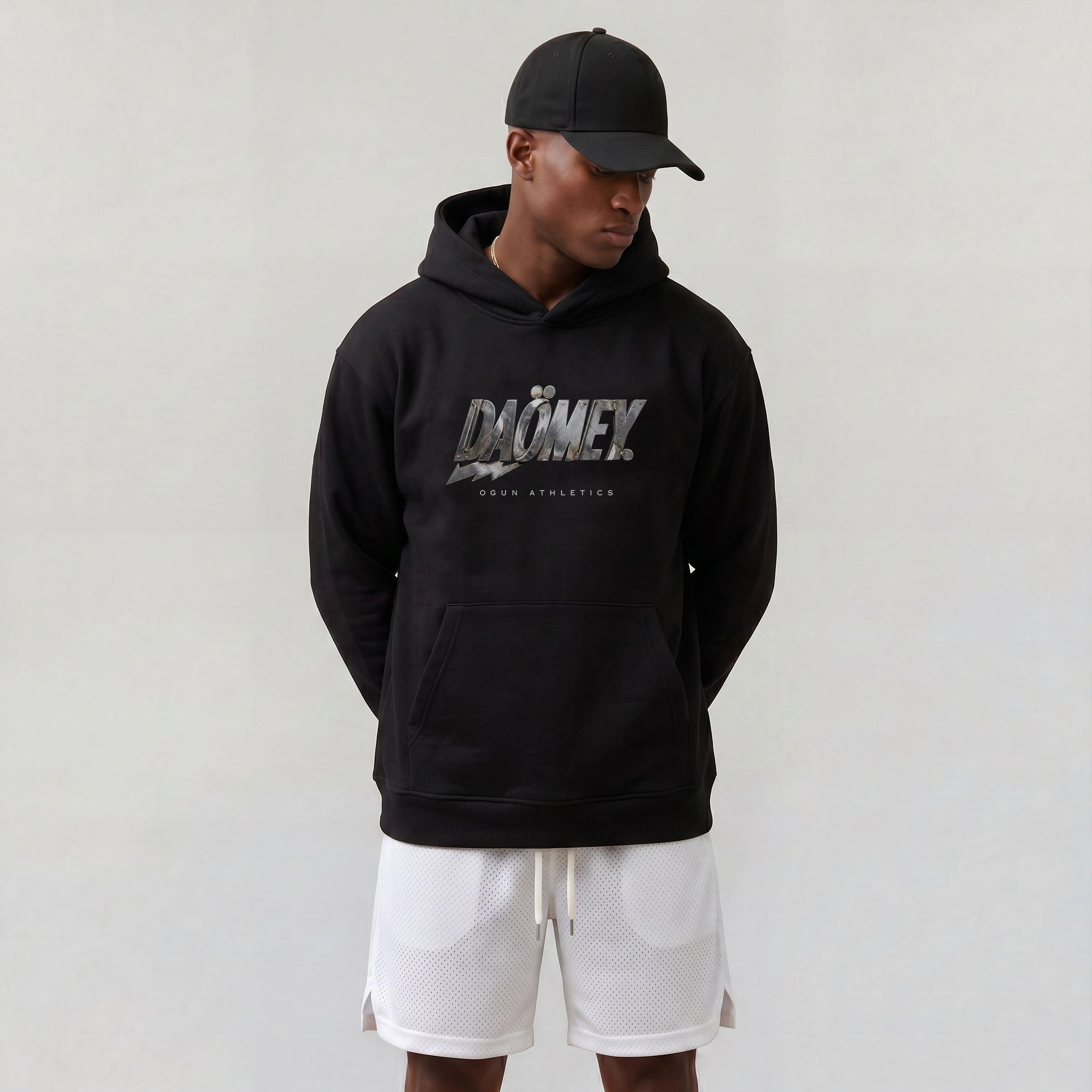 Person wearing a black hoodie with 'DOMEX' branding and white shorts on a plain background